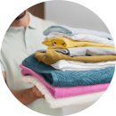 man-holding-pile-clean-clothes-1-modified-min